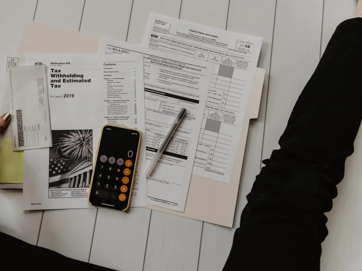 Accountant firm website shown on a laptop with services list, credentials and a WhatsApp consultation booking button (Multan)