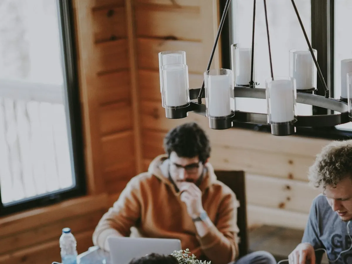 Coworking space website shown on a phone with membership plans, desk photos and a WhatsApp tour booking button