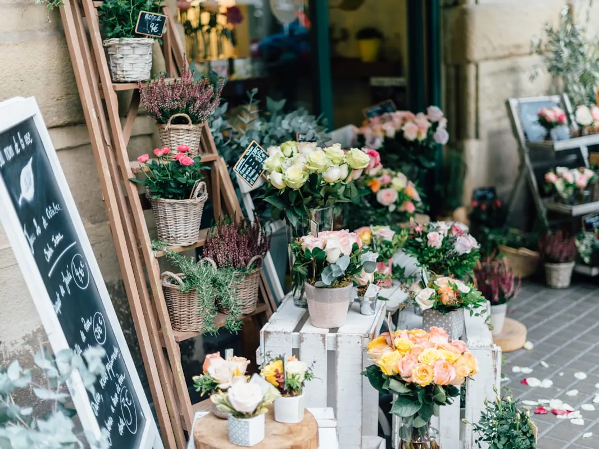 Florist website shown on a phone with a bouquet catalog, occasion categories and a WhatsApp order button (Mingora (Swat))