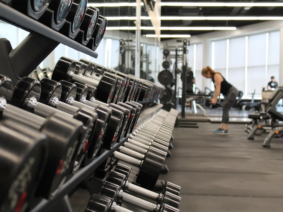 Gym website shown on a laptop with membership plans, class schedules and facility photos