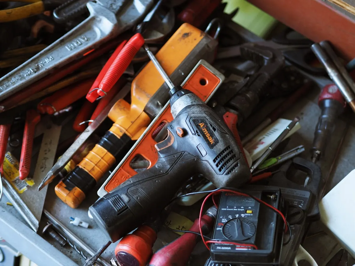 Hardware store website on a phone showing product categories, brands carried and a WhatsApp bulk order button (Gilgit)
