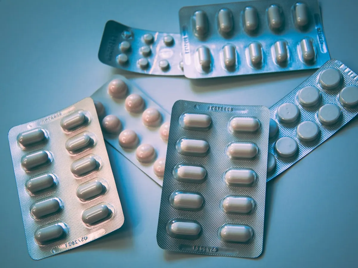 Pharmacy website shown on a phone with a medicine list, WhatsApp prescription upload button and delivery info (Mirpur)