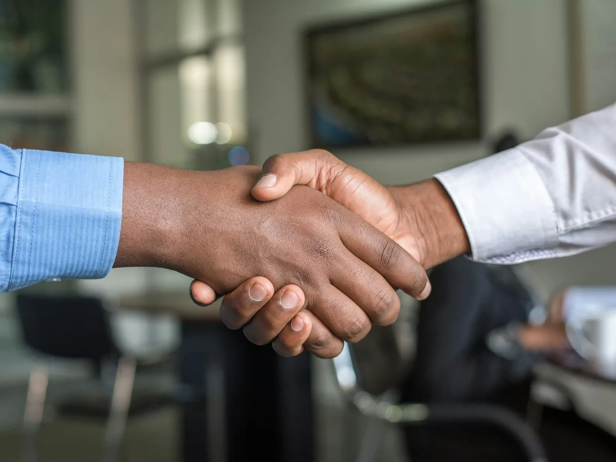 A handshake representing Staffly, a verified domestic staffing platform in Pakistan built by Origin Labs